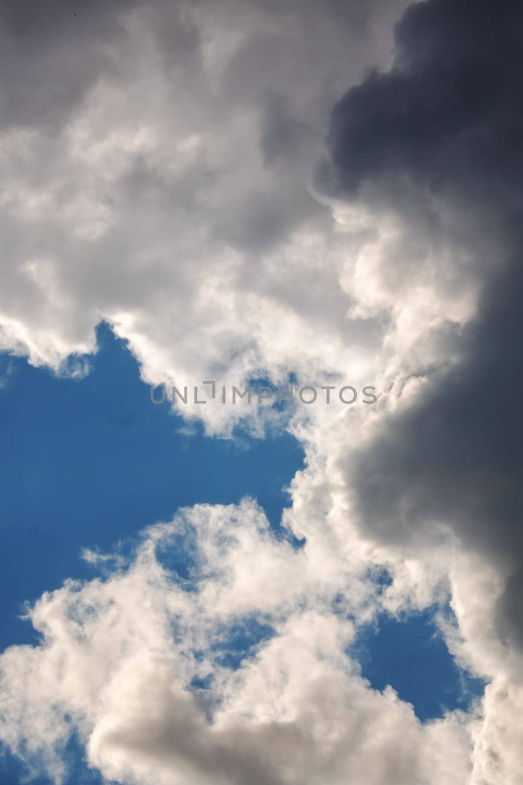 White clouds in bright blue sky close up