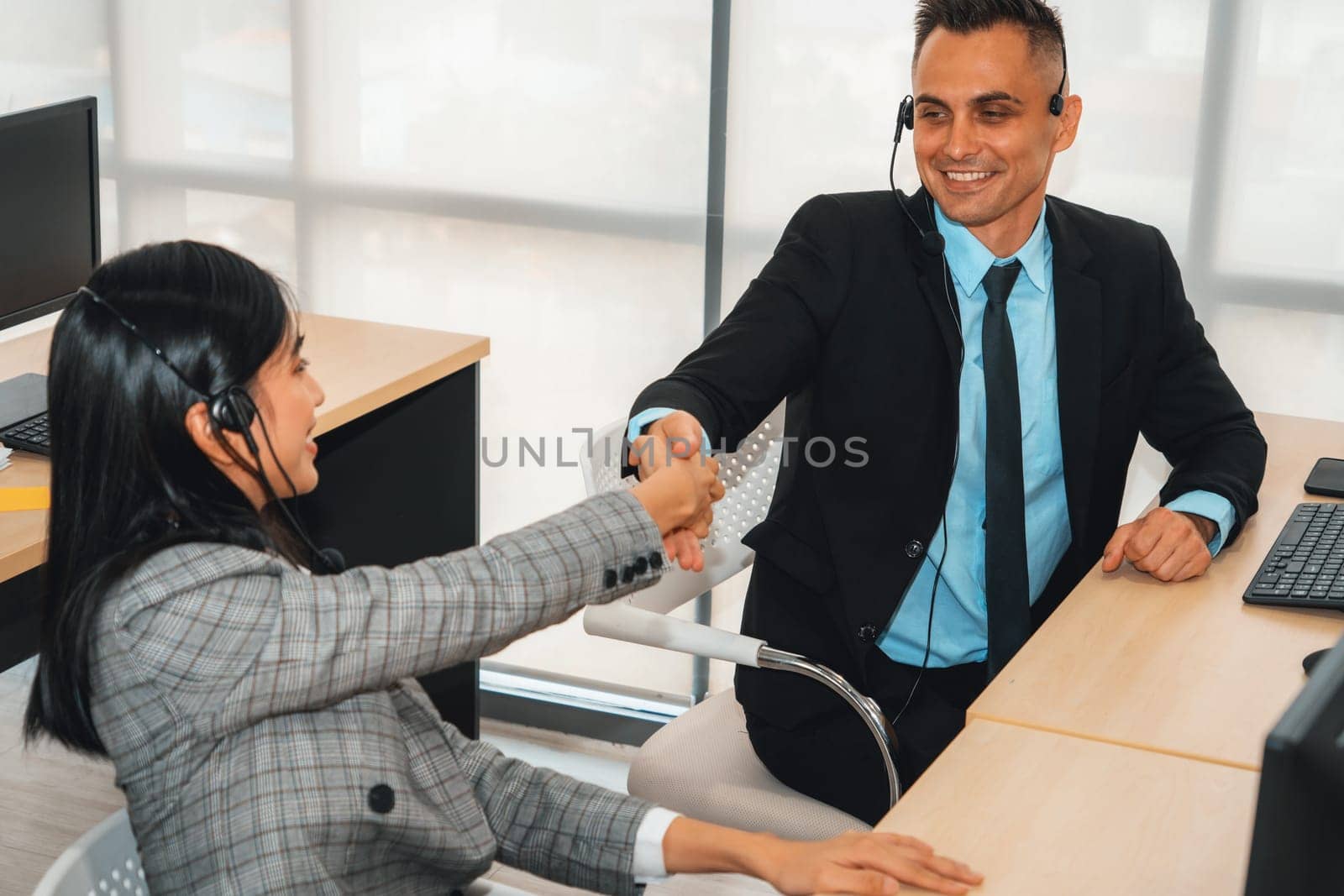 Business people wearing headset celebrate working in office Jivy by biancoblue