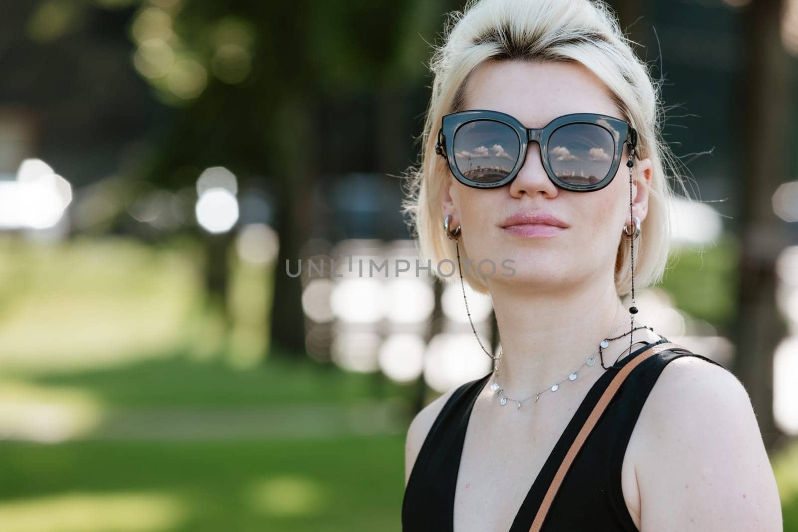 Young attractive girl happy positive smile wear sunglass summer nature outdoors by sarymsakov