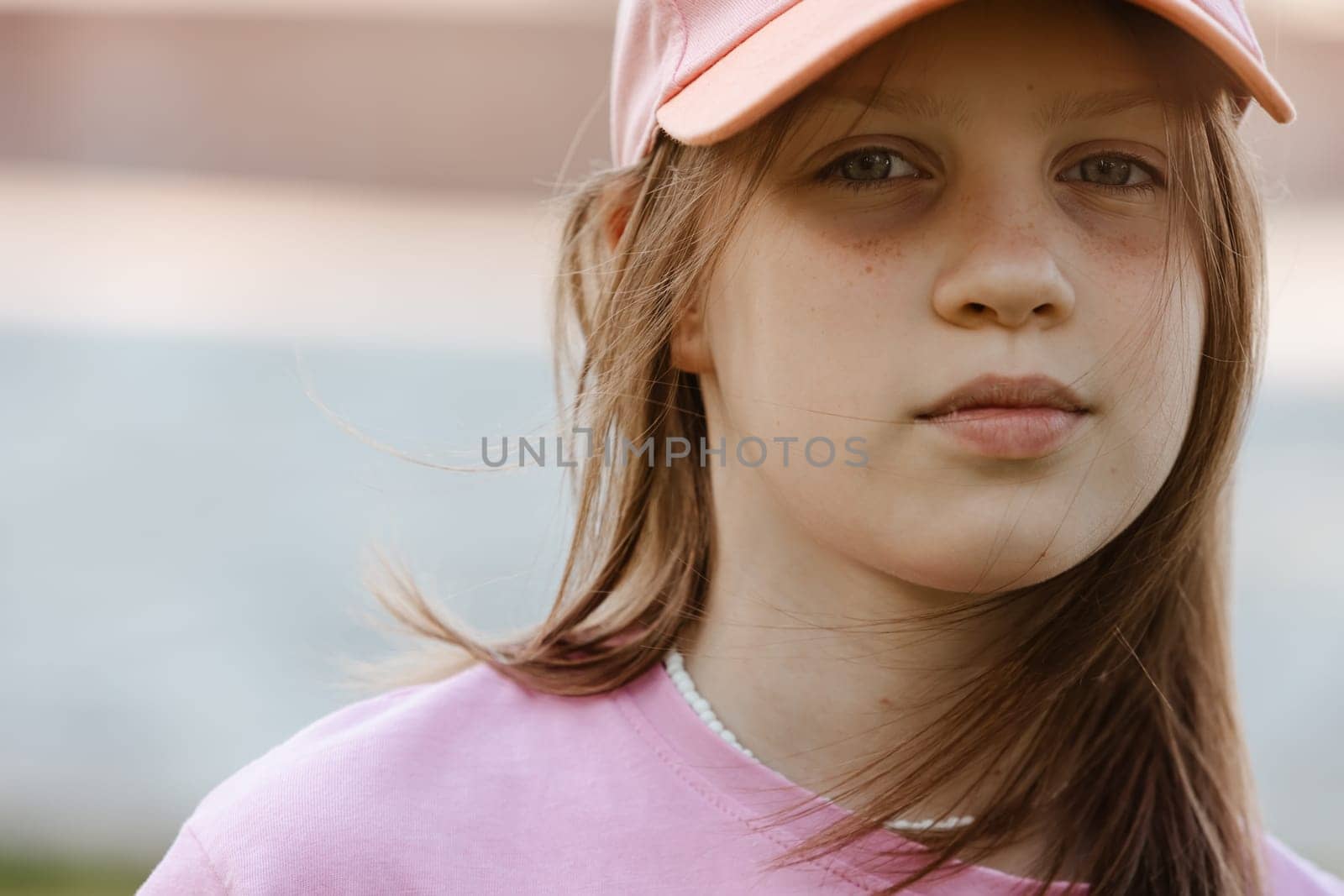 Close up portrait of a ten year old girl, smiling up at the camera. Positive emotion by sarymsakov