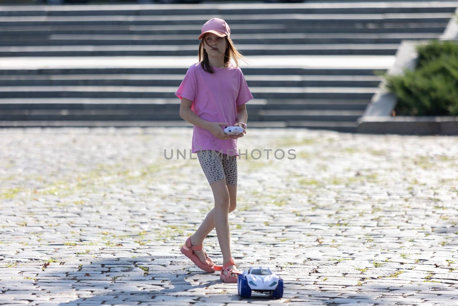 Girl playing with remote control car.