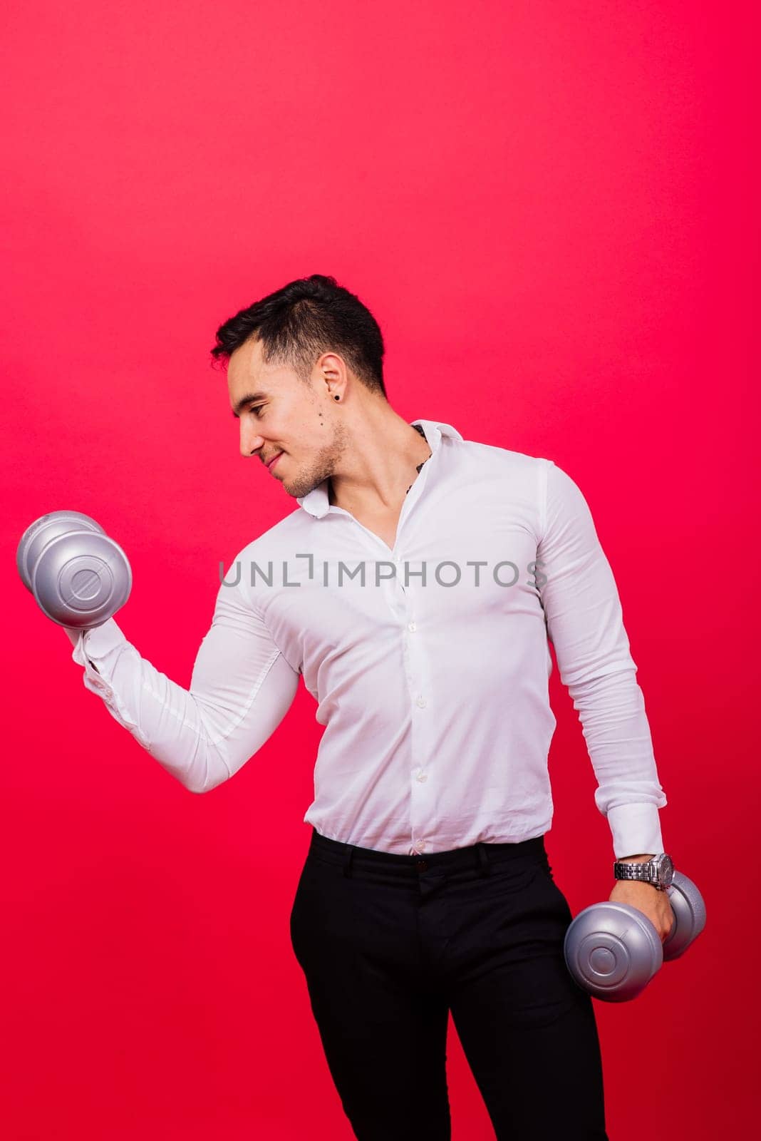 Business man with fitness dumbbells wear shirt. Studio shooting on red background by Zelenin