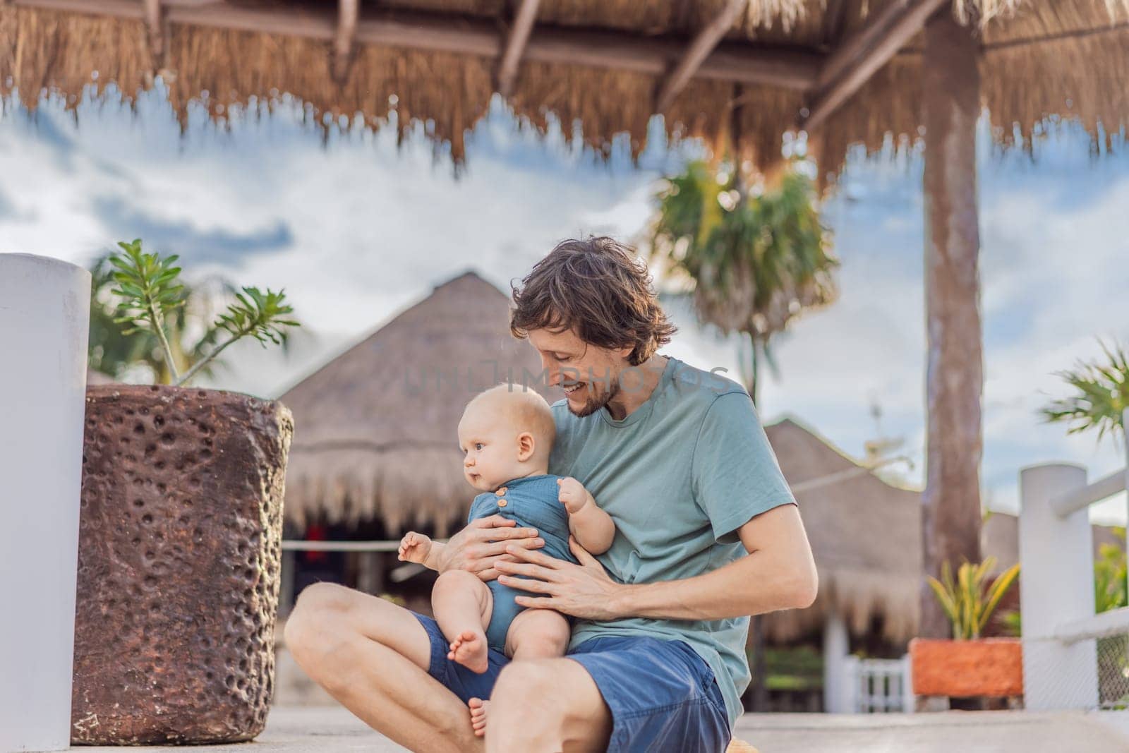 In a heartwarming outdoor scene, a caring dad and his baby share quality time, creating precious family memories amidst nature's beauty.