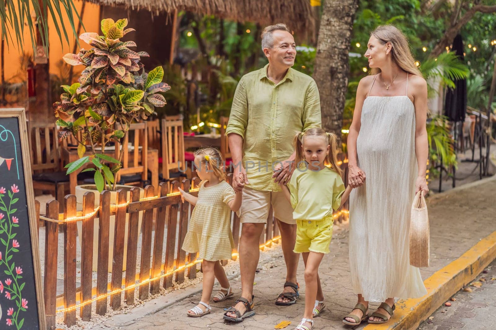 A joyful family, two girls, dad, and a pregnant mom, bask in tropical resort, celebrating a radiant pregnancy amidst paradise by galitskaya