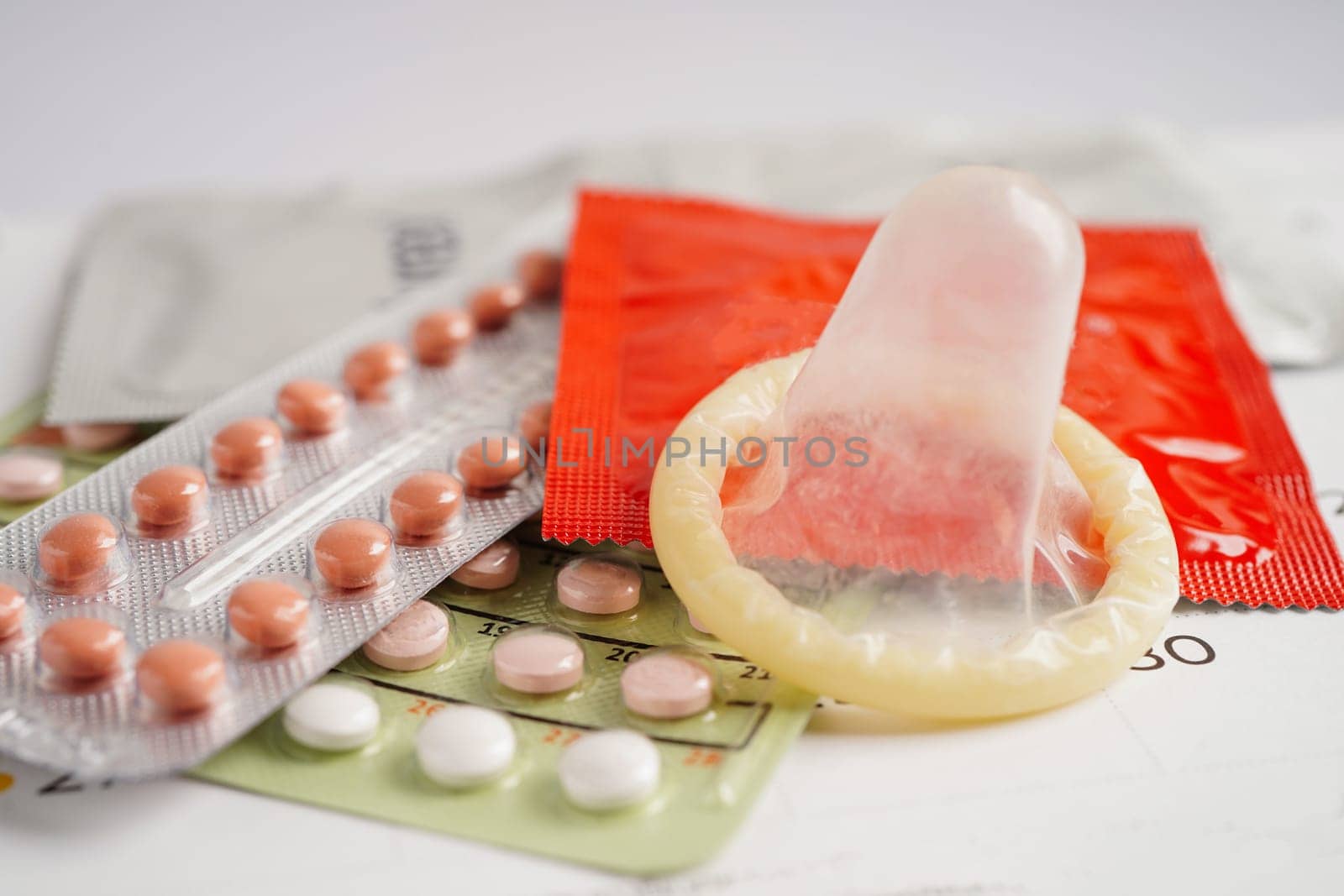 Pregnancy test with birth control pills for female on calendar, ovulation day.