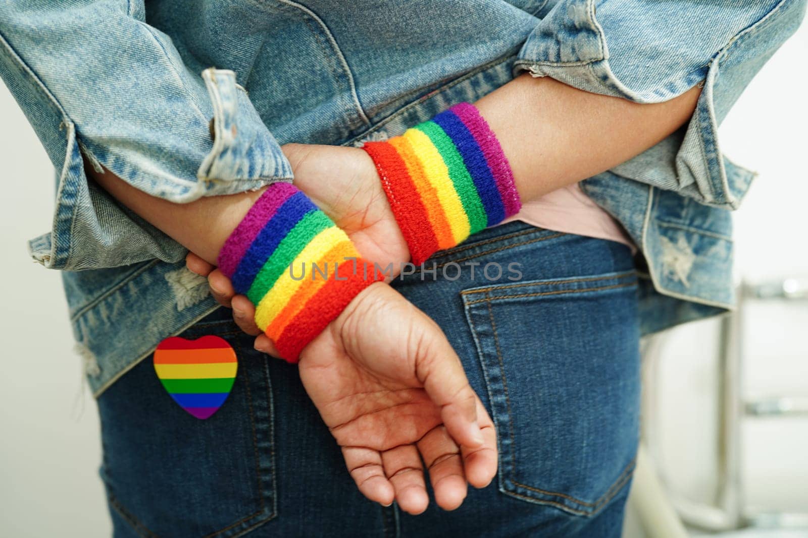 Asian woman with rainbow flag, LGBT symbol rights and gender equality, LGBT Pride Month in June.