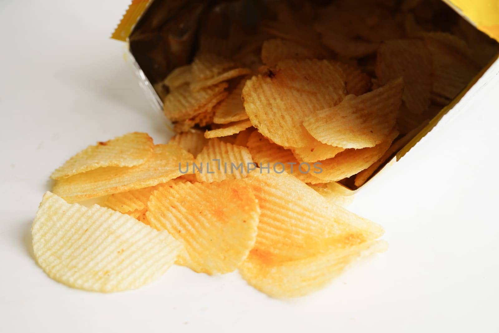 Potato chips in open bag, delicious BBQ seasoning spicy for crips, thin slice deep fried snack fast food.