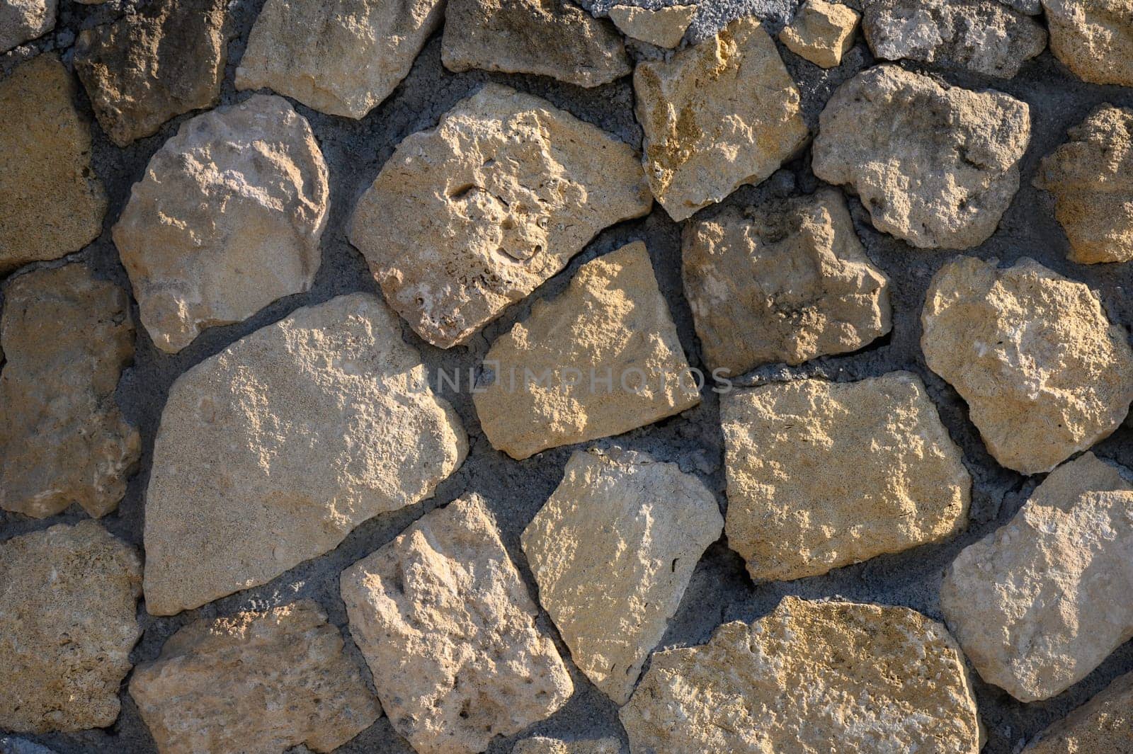 Weathered stones offer earthy texture against a bright backdrop, blending nature and craftsmanship beautifully.