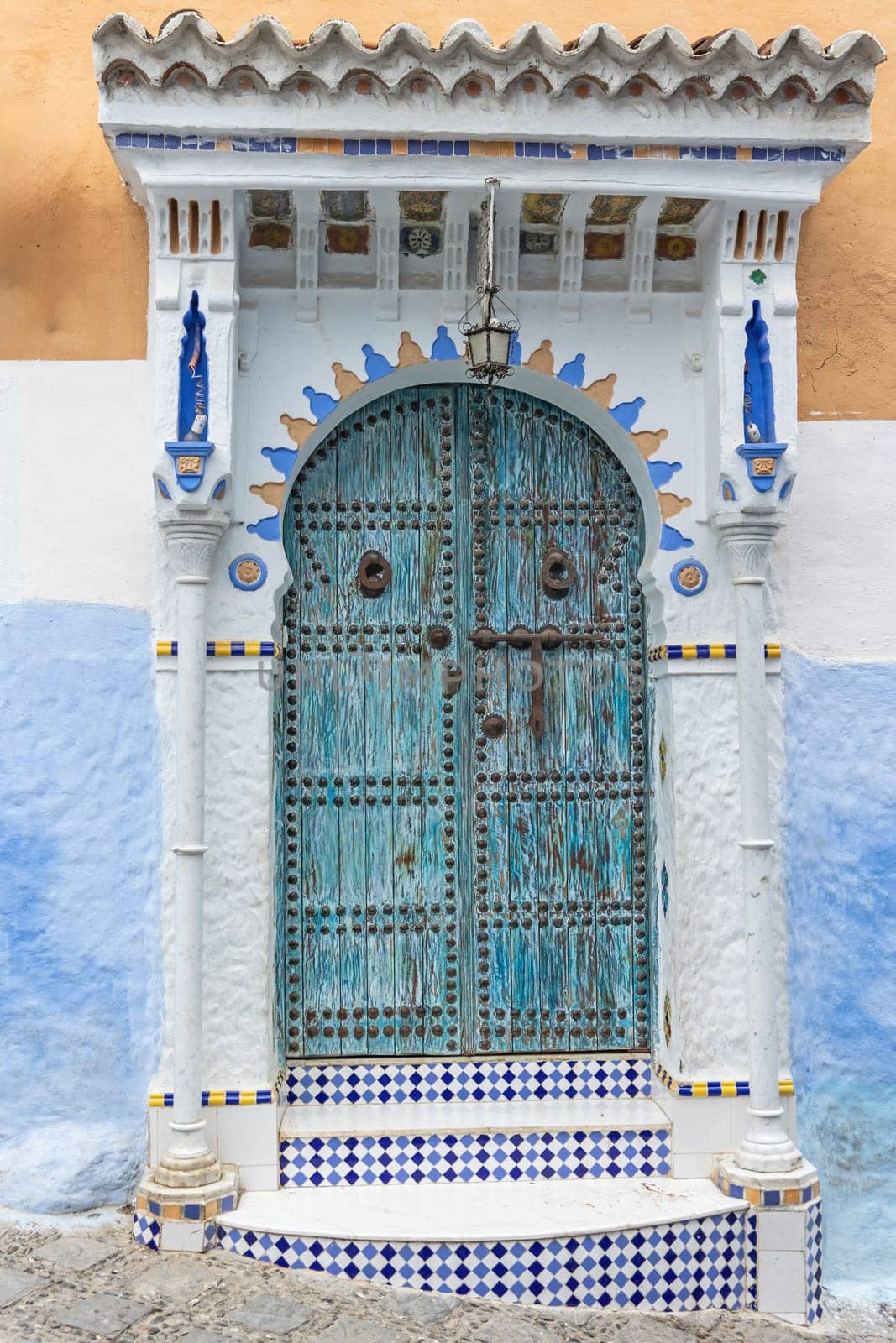 Ornate blue and white door closeup. Blue City of Chefchaouen. Morocco. Vertically. 