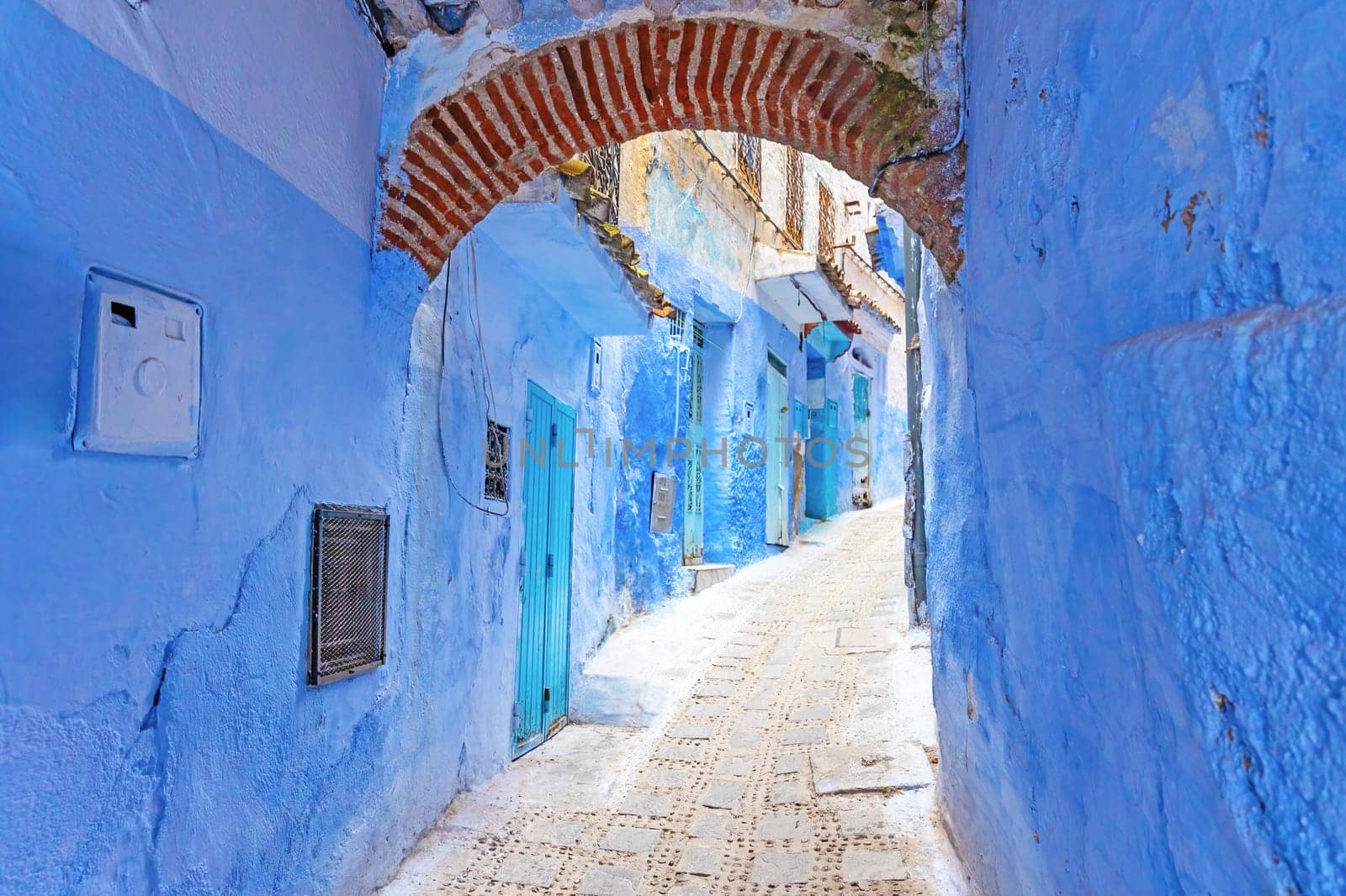 Blue archway in a empty  street in the city of Chefchaouen.  Morocco.  Horizontally. Morocco. 