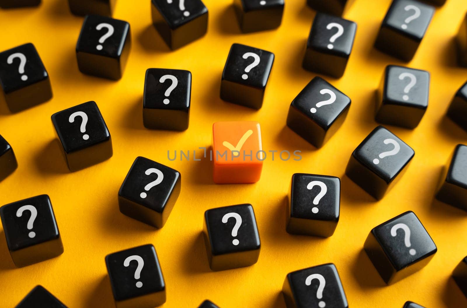 An orange check mark among many question marks. Correct answer. Task completion. Open achievement. Many unknown things and challenges. Fulfillment of requirements.