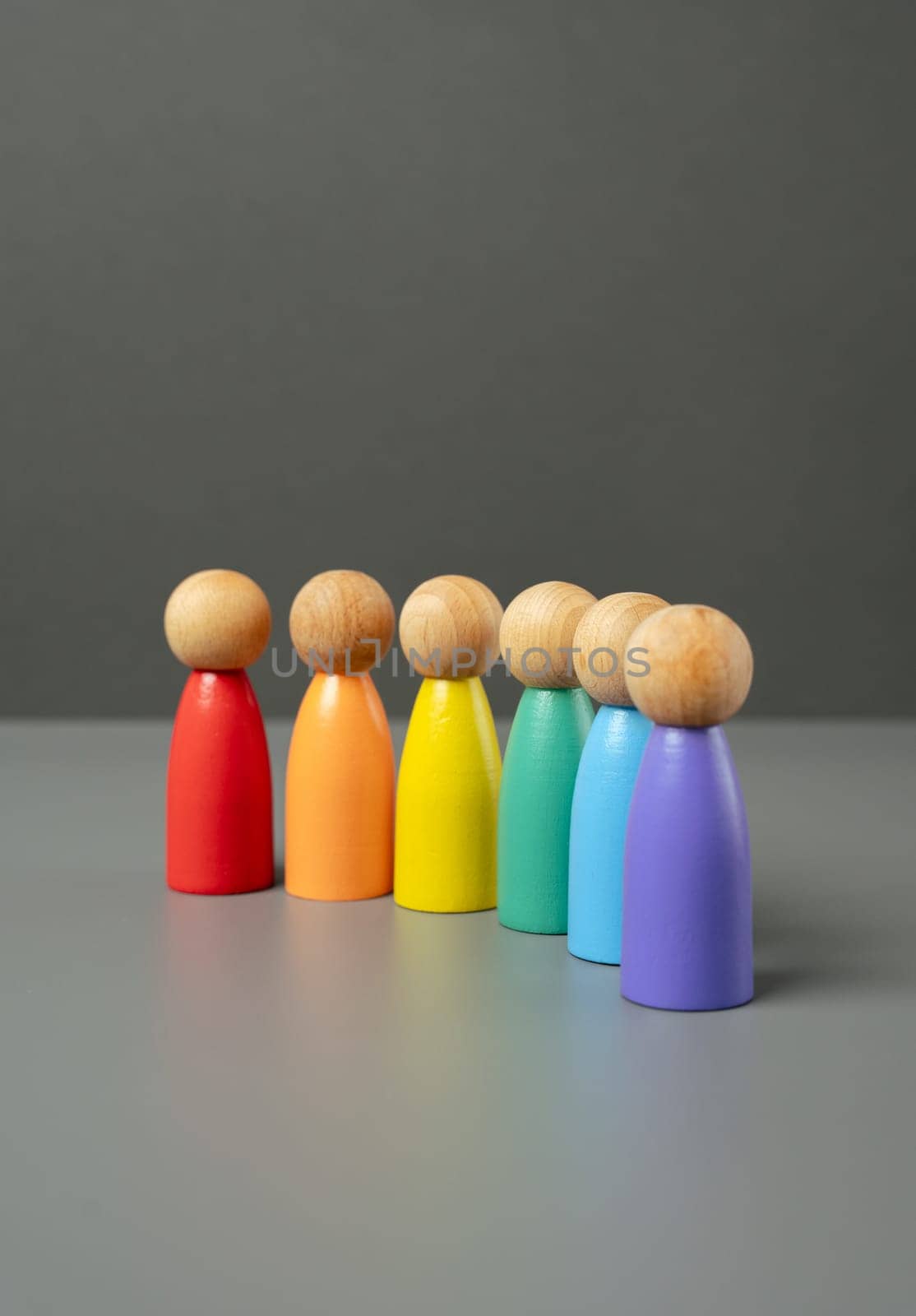 Figures of people lined up in the colors of the LGBT flag. Lesbian, gay, bisexual, and transgender. International Pride Day. Protection of the rights and freedoms of sexual minorities.