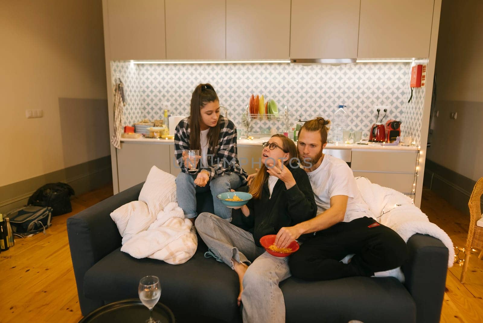 A relaxed and enjoyable gathering of close friends sharing delicious food and laughter in a modern living space