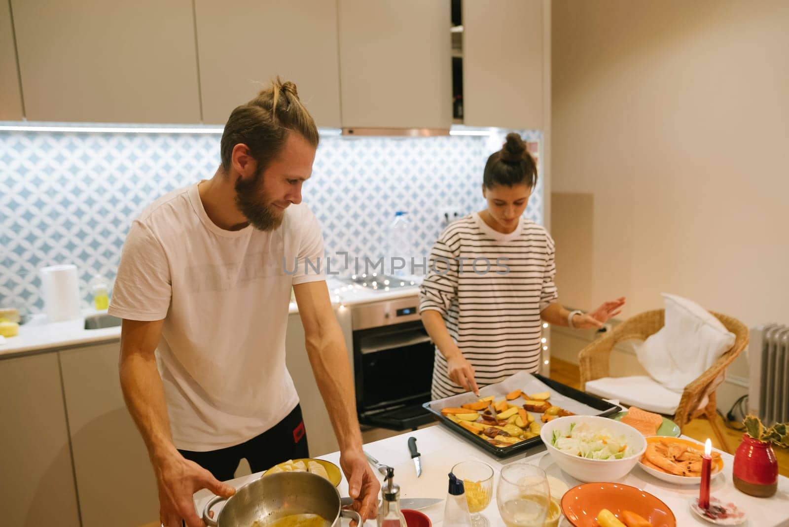 A couple lovingly prepares a wholesome meal together in a cozy, stylish kitchen that feels like home