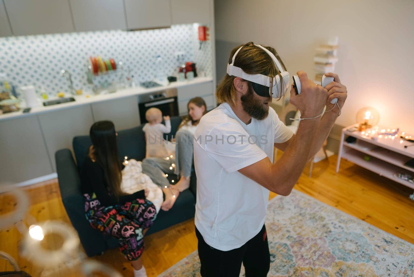 A happy and joyful family is enjoying some exciting virtual reality gaming together in a cozy modern home setting