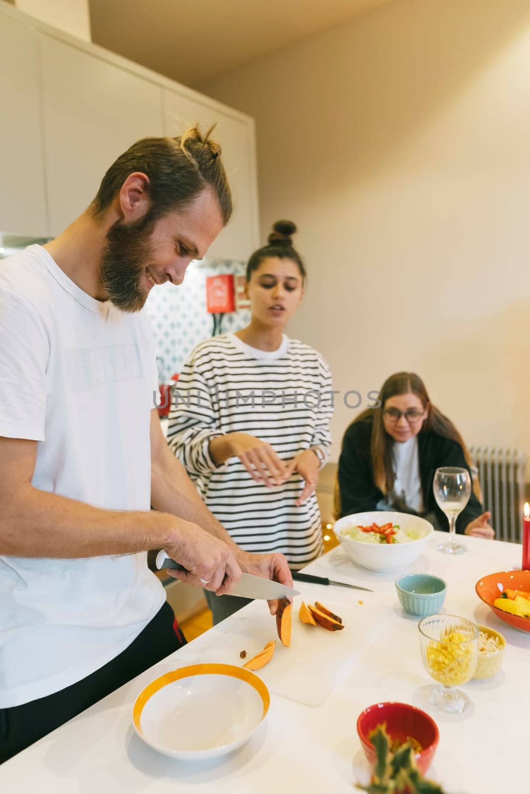 A vibrant kitchen scene with friends cooking together, showcasing teamwork and delicious food preparation.