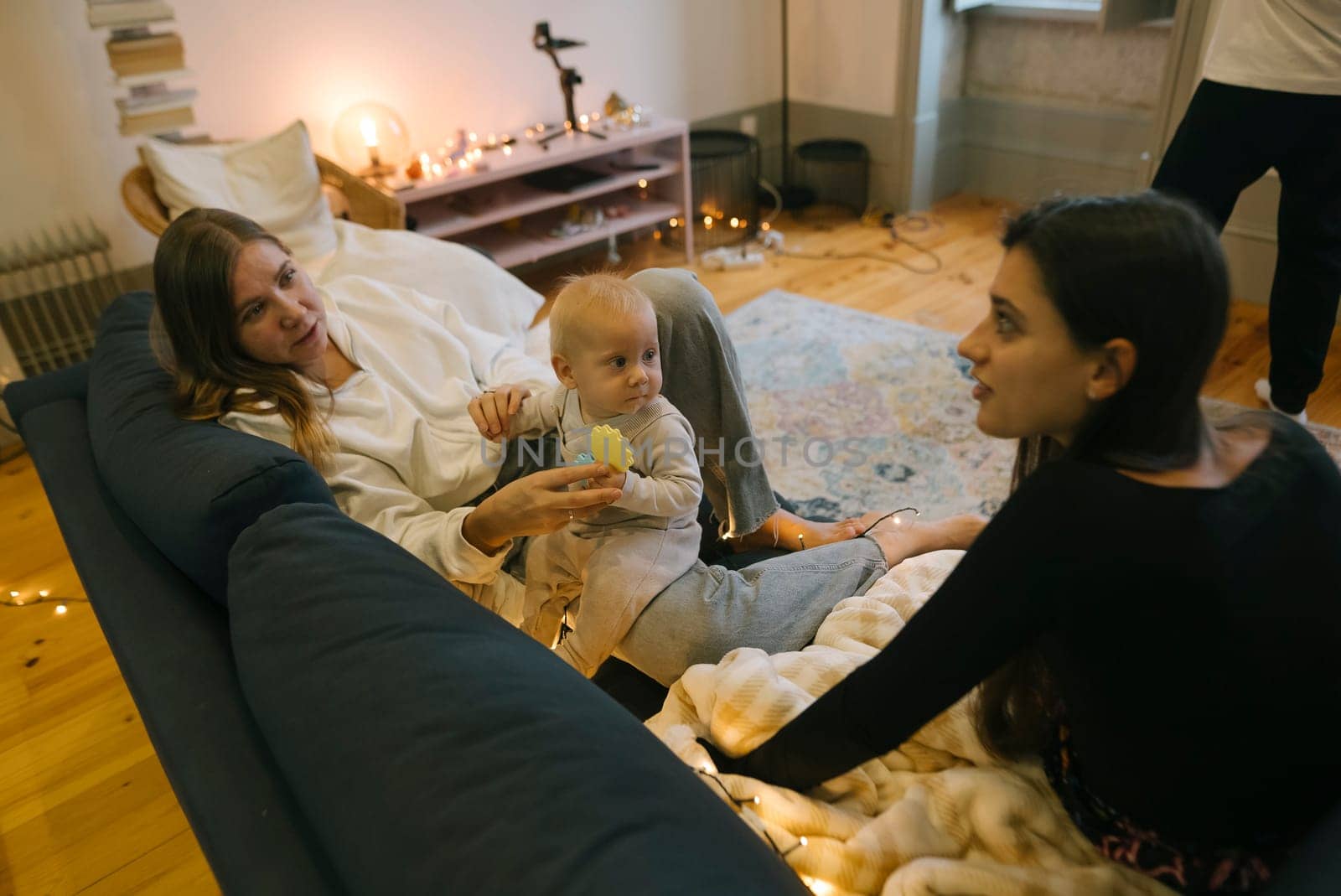 A heartwarming scene where a loving family is joyfully interacting playfully with their adorable baby