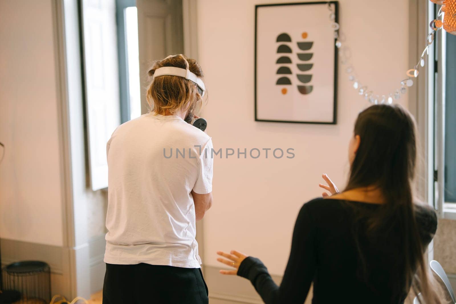 Two individuals engaged in a creative moment indoors, beautifully showcasing collaboration, motivation, and inspiration