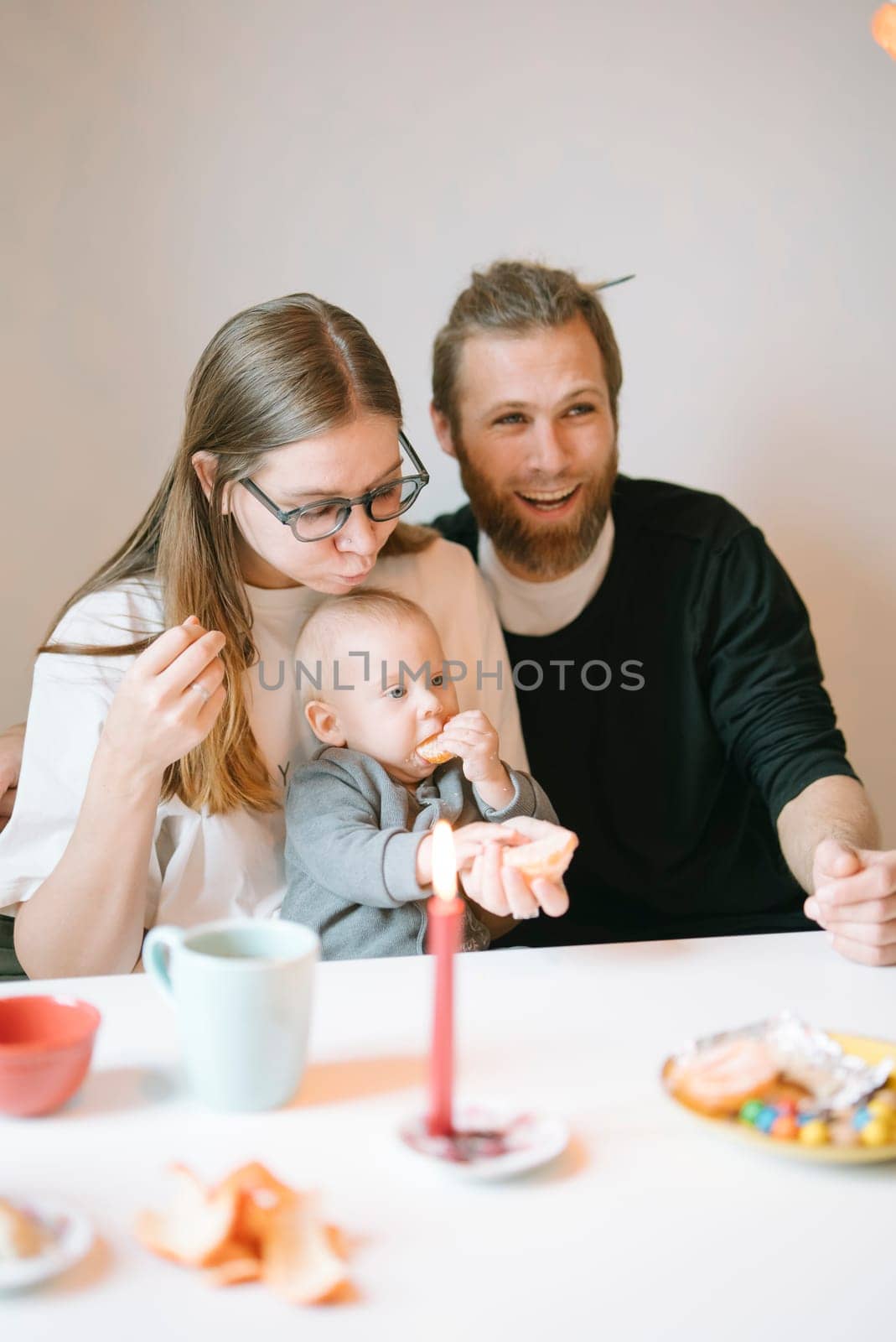 A loving family joyfully shares moments together, enjoying tasty snacks and bonding closely with each other