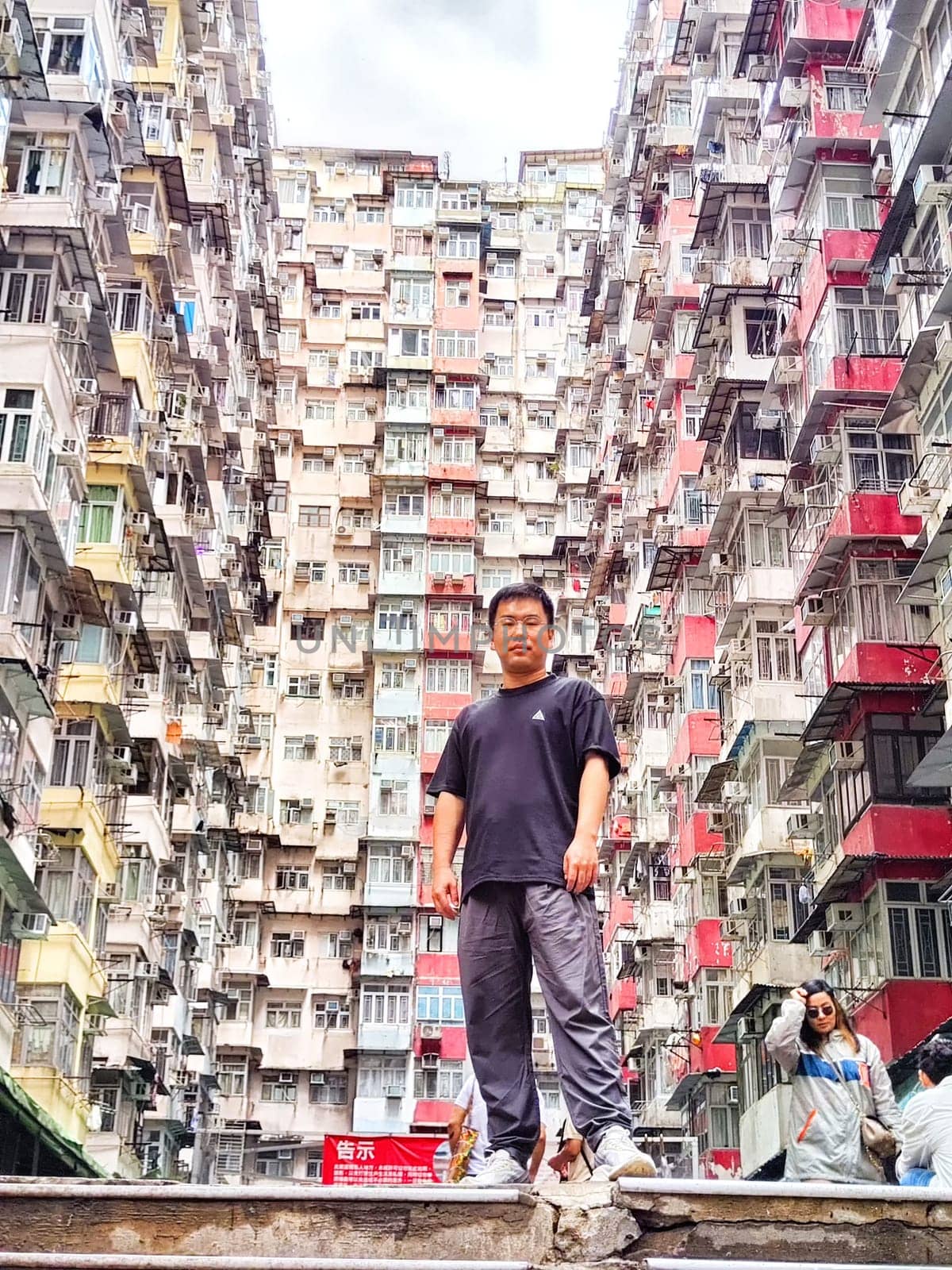 Hong Kong, China - April 06, 2024 - Visitors gather around the famous monster apartment building in Hong Kong, marveling at its unique design and height. The monster House.