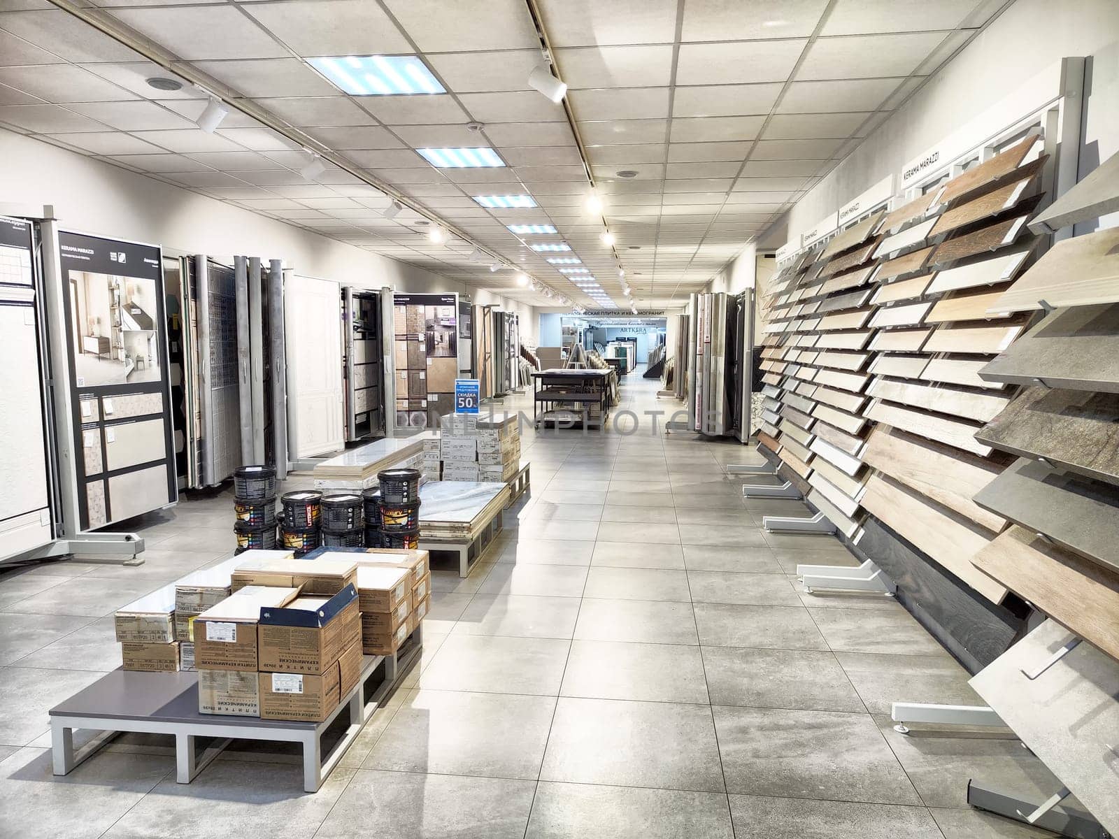 Kirov, Russia - November 27, 2024 - Customers explore an extensive selection of ceramic tiles while navigating through clean and organized aisles.