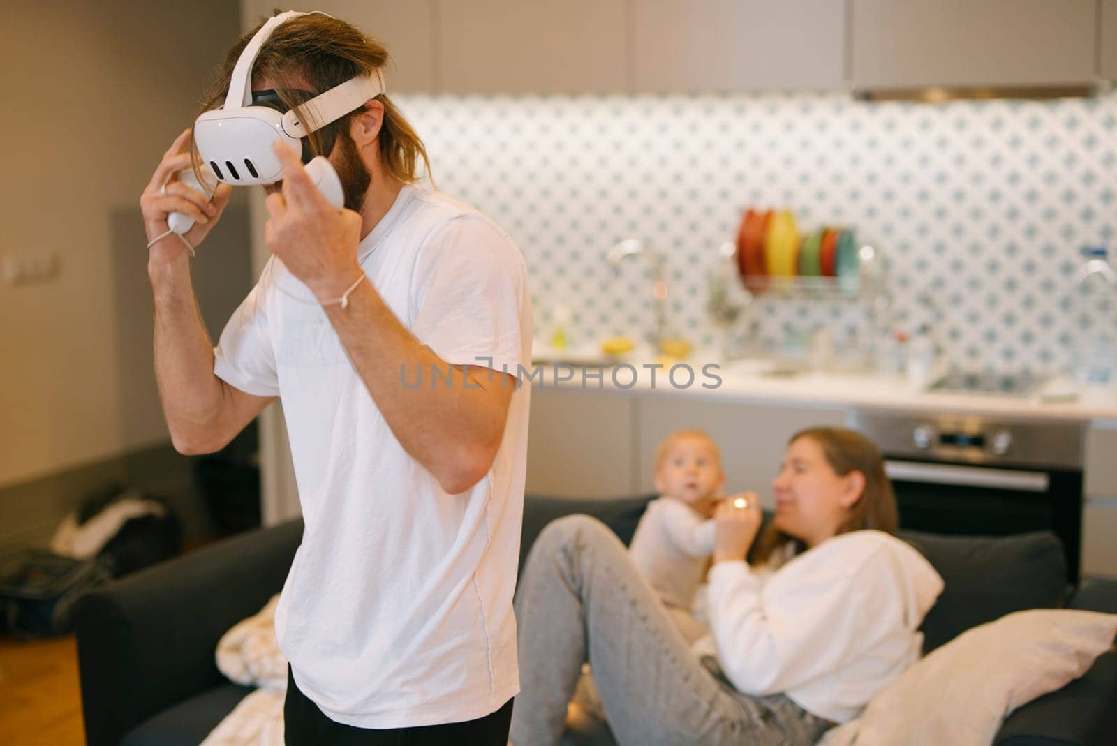 A family happily engages in virtual reality gaming together, showcasing modern technology in a cozy home