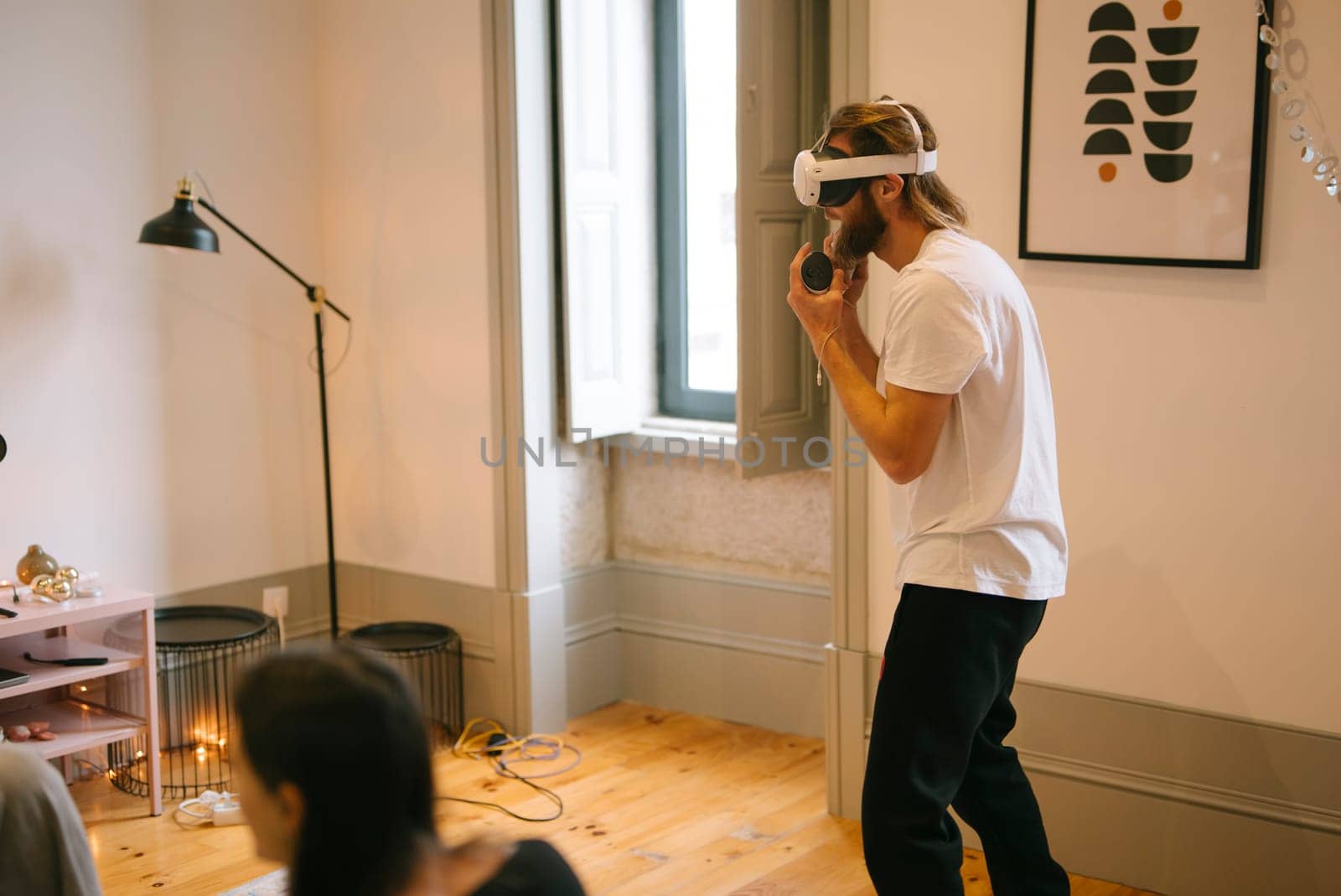 A person donning a virtual reality headset mesmerizes everyone in the room with an incredibly immersive experience