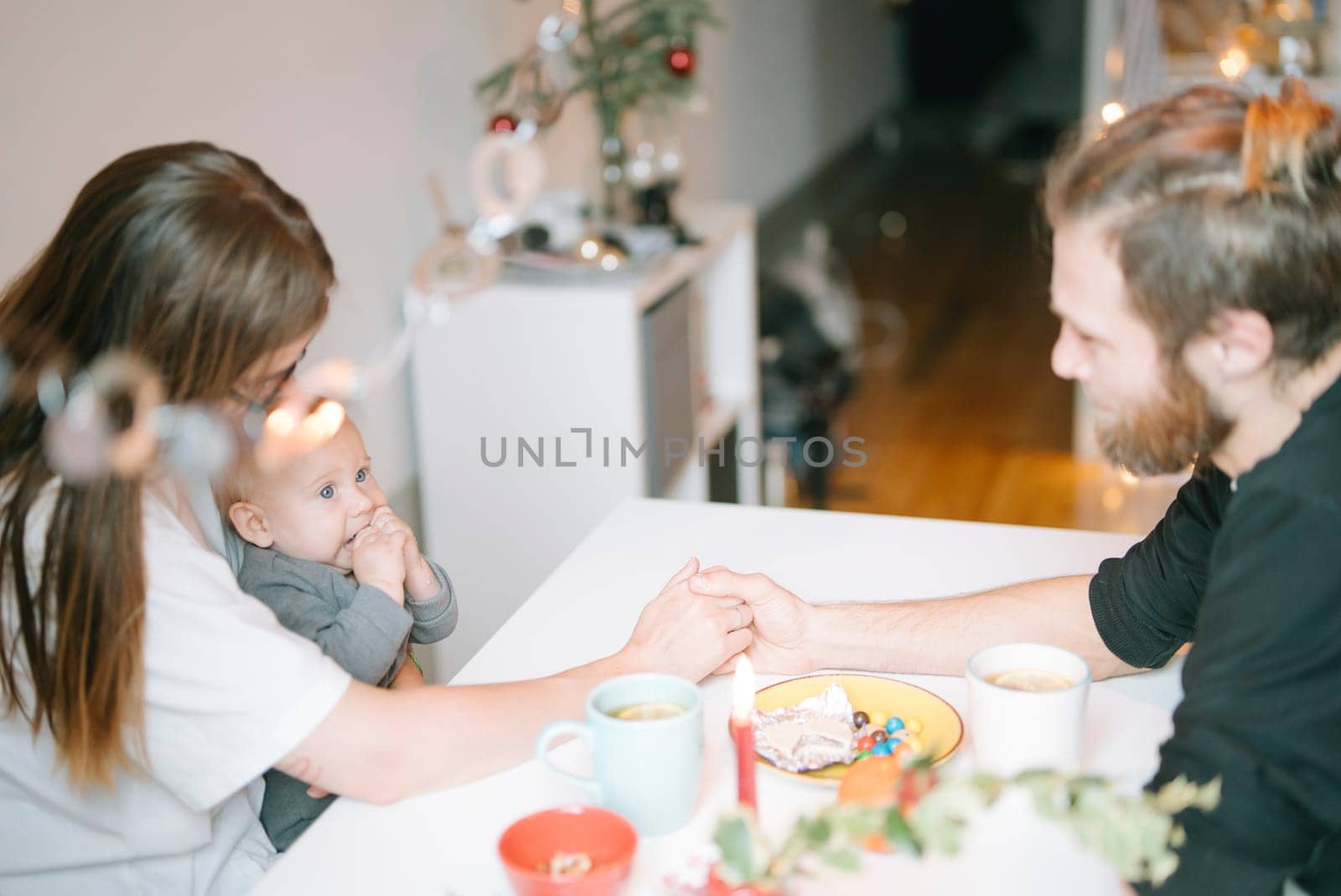 A heartwarming family moment with a baby at the dining table, joyfully enjoying coffee and connection