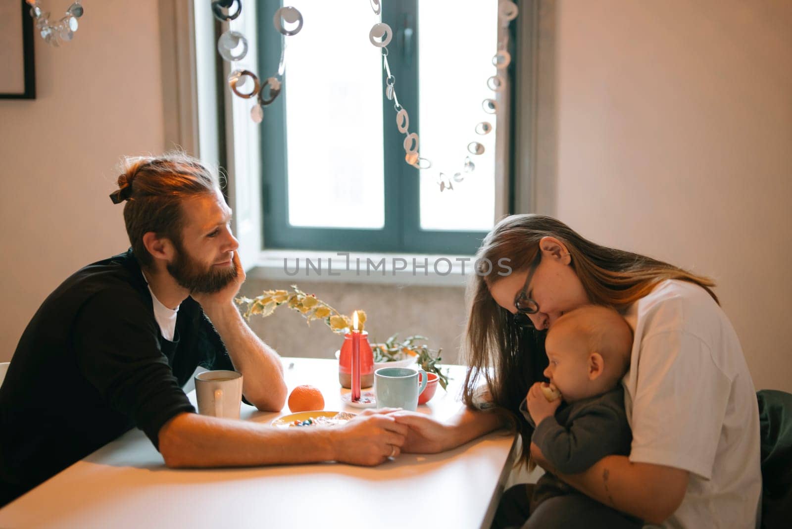 A serene moment for the family as loving parents bond with their baby at home, fostering deep love and connection
