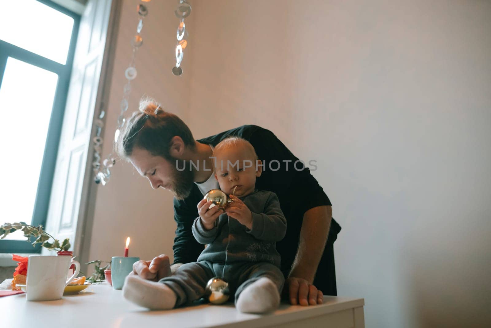 A heartwarming and joyful scene showcasing a loving father and his child delighting in festive moments together