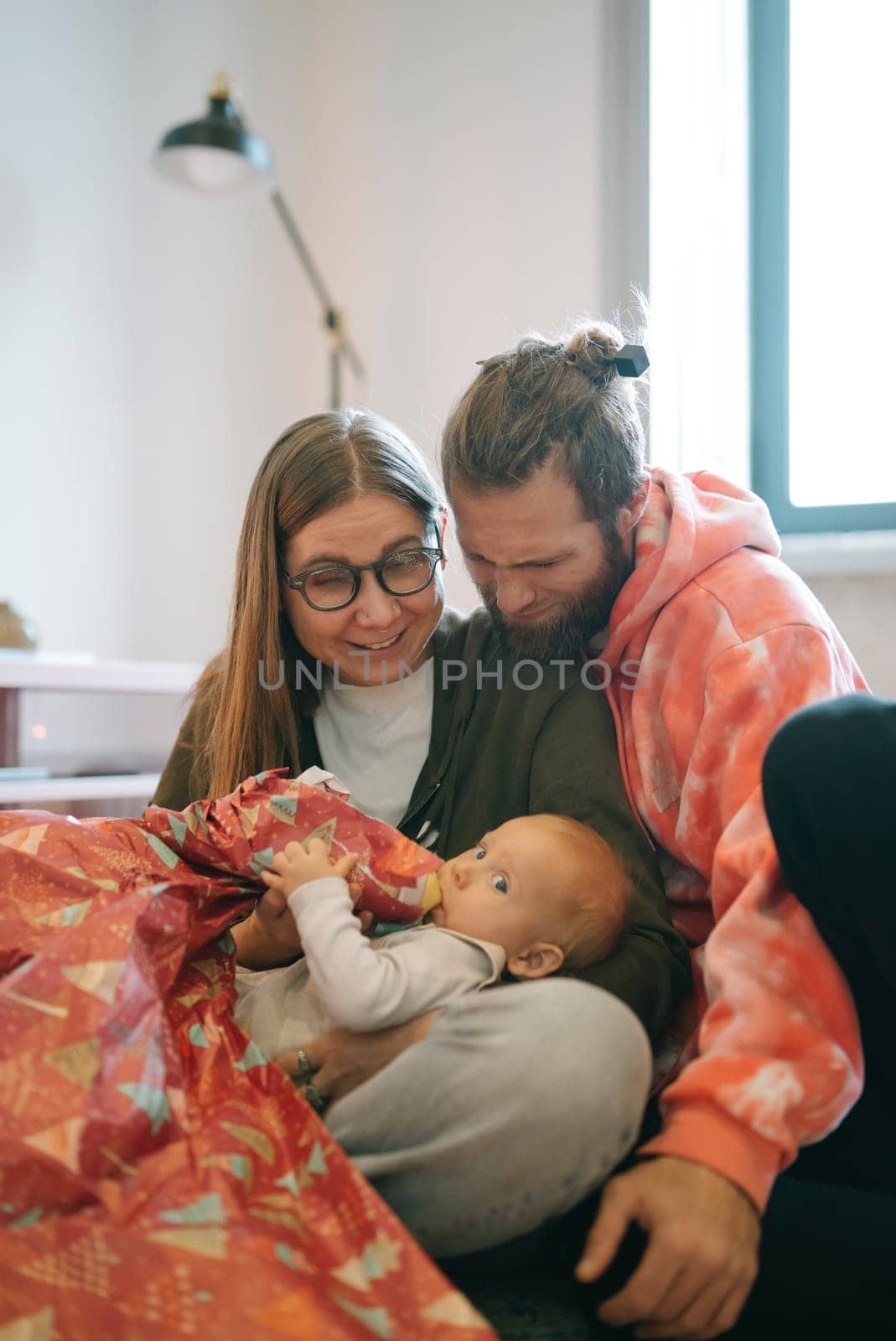 A heartwarming moment as loving parents interact affectionately with their baby, showcasing joy and love
