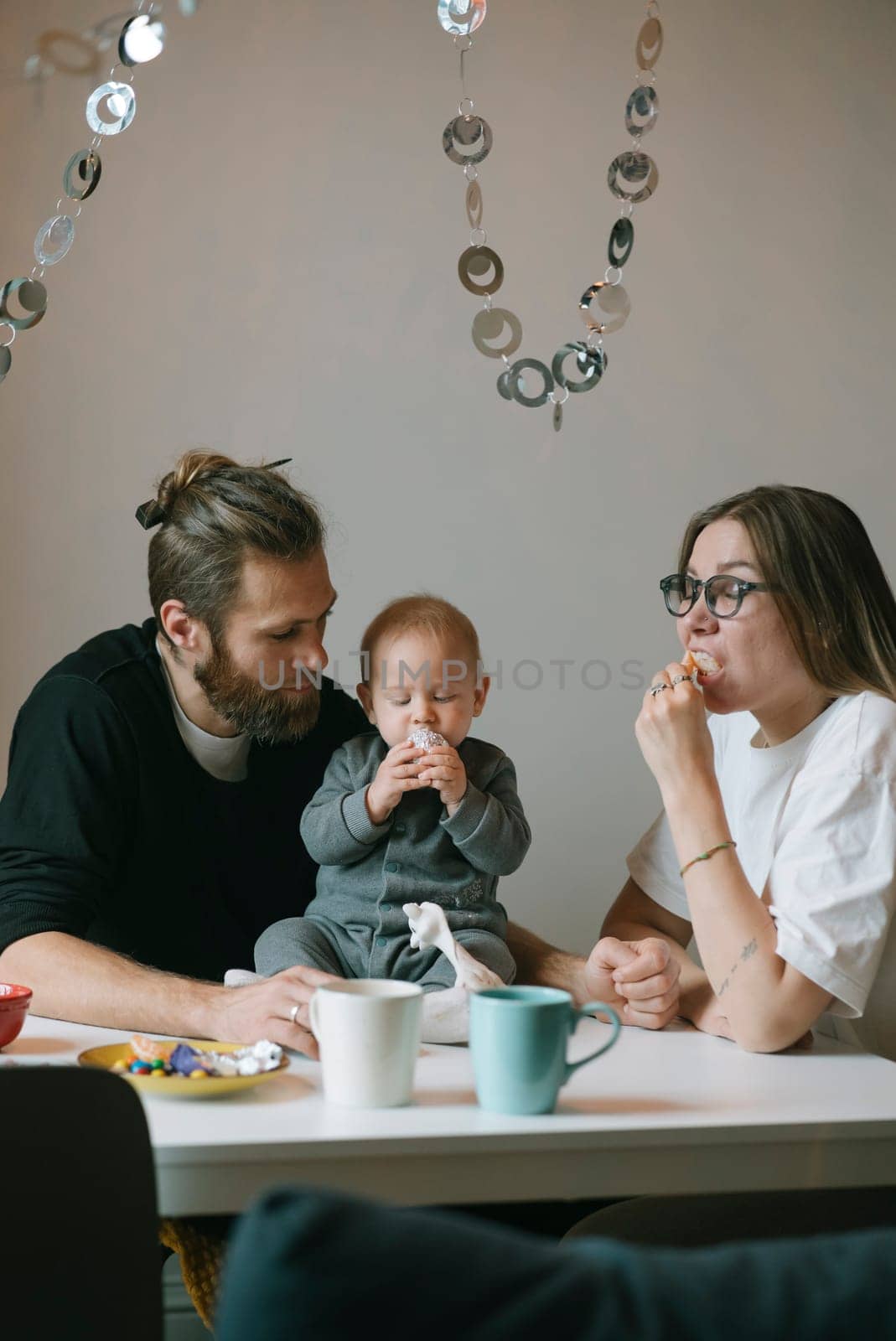 A loving family gathers together, sharing quality time filled with snacks and laughter in their cozy home