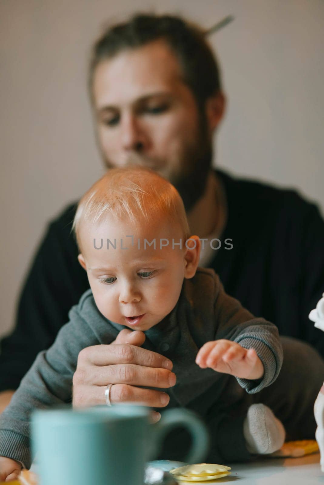A touching moment between a dad and his baby during playtime at home, showcasing love and connection.