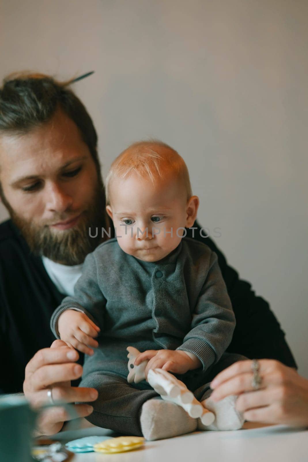 A heartwarming moment shows a father interacting lovingly with his adorable baby in a calm, peaceful setting