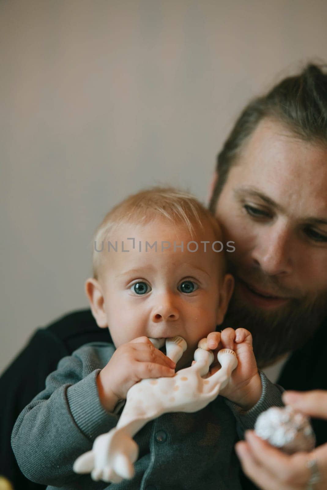 A heartwarming scene of a devoted father lovingly and playfully interacting with his curious little baby