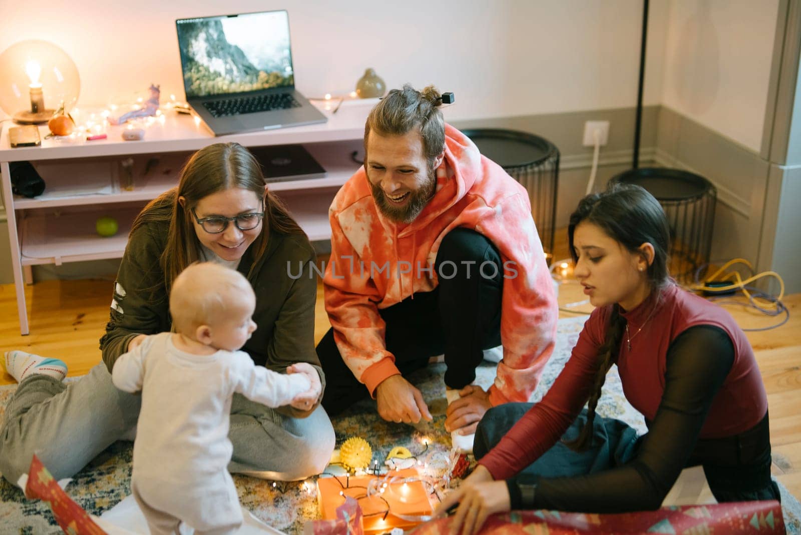 A joyful family gathering featuring a delightful baby, sharing laughter and warmth in a cozy, inviting living room