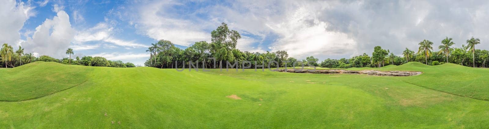 Scenic panorama of a tropical golf course surrounded by lush jungle. Serene landscape ideal for relaxation, sports, and luxury travel. Nature, recreation, and tropical getaway concept.