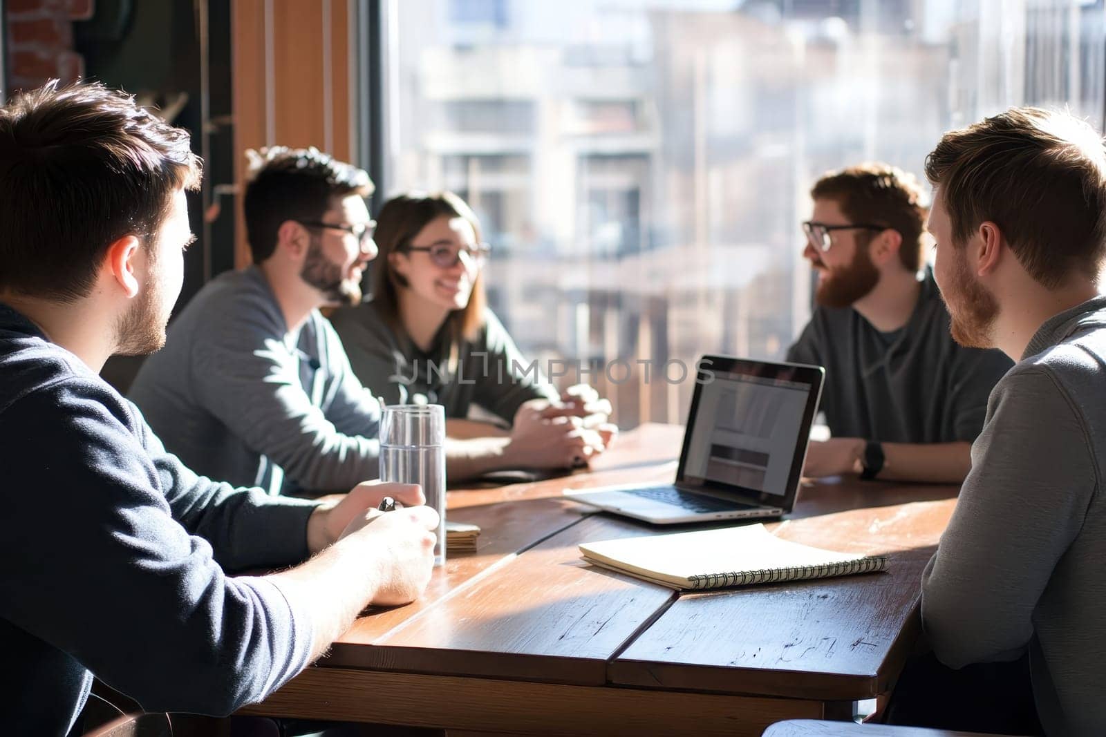 A vibrant team meeting in a modern workspace showcasing professionals engaged in collaboration and discussion. Ideas flow in a bright atmosphere.
