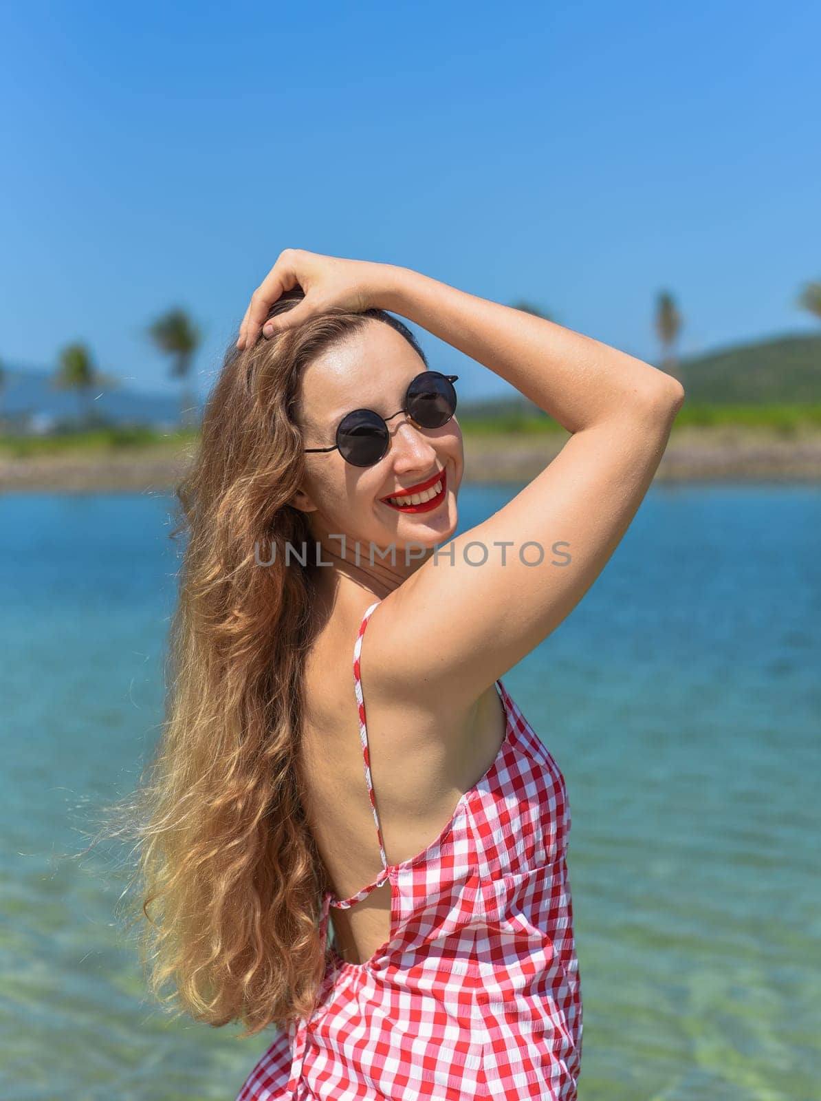 Bright blond young woman standing in sea in summer
