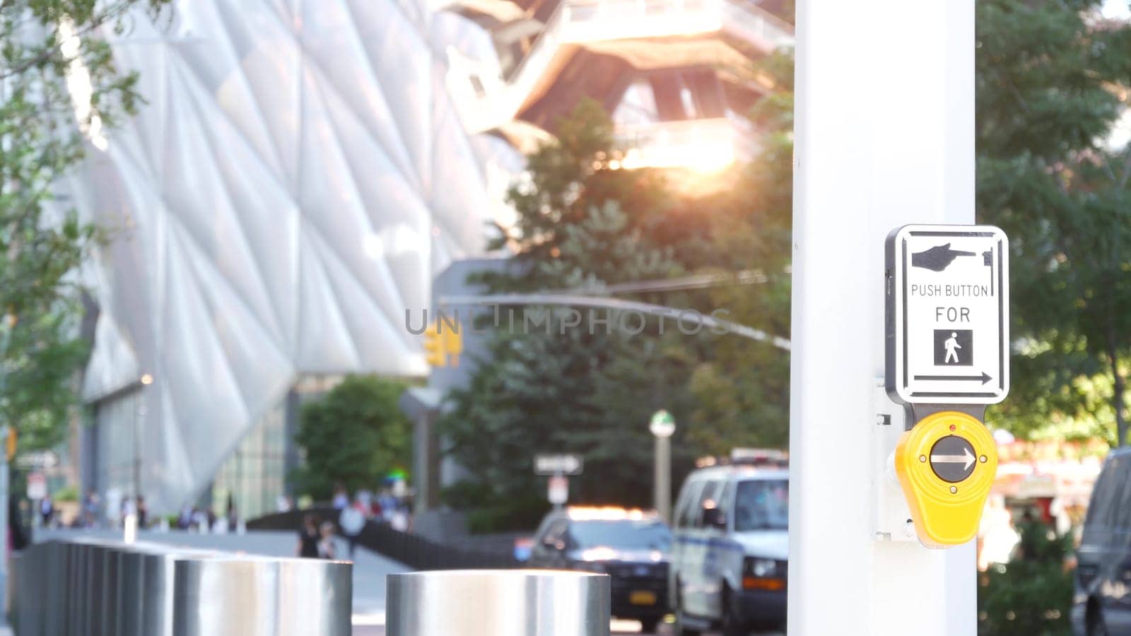 New York City, United States - 1 Sept 2023: Hudson Yards architecture in Chelsea, Manhattan Midtown Vessel, NYC, USA. Defocused people, urban road traffic, 34 street. Crossroad traffic light button.
