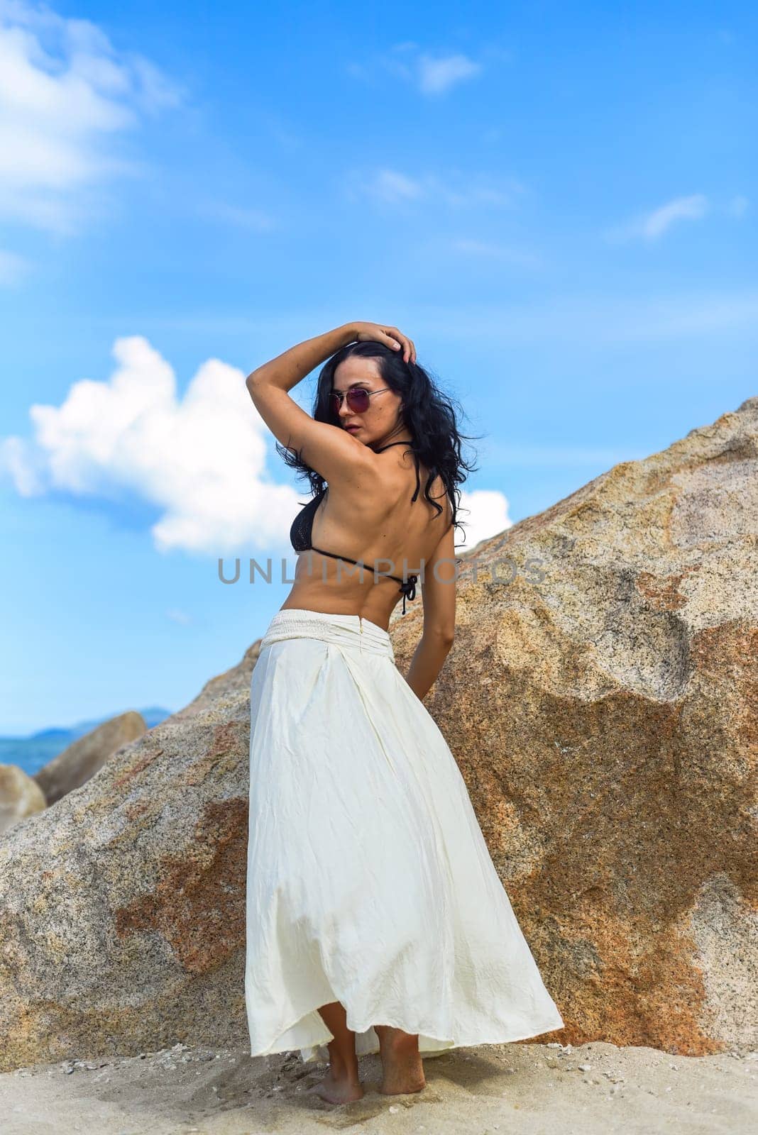 Young ukrainian woman in bikini standing against cityscape of Nha Trang, Vietnam