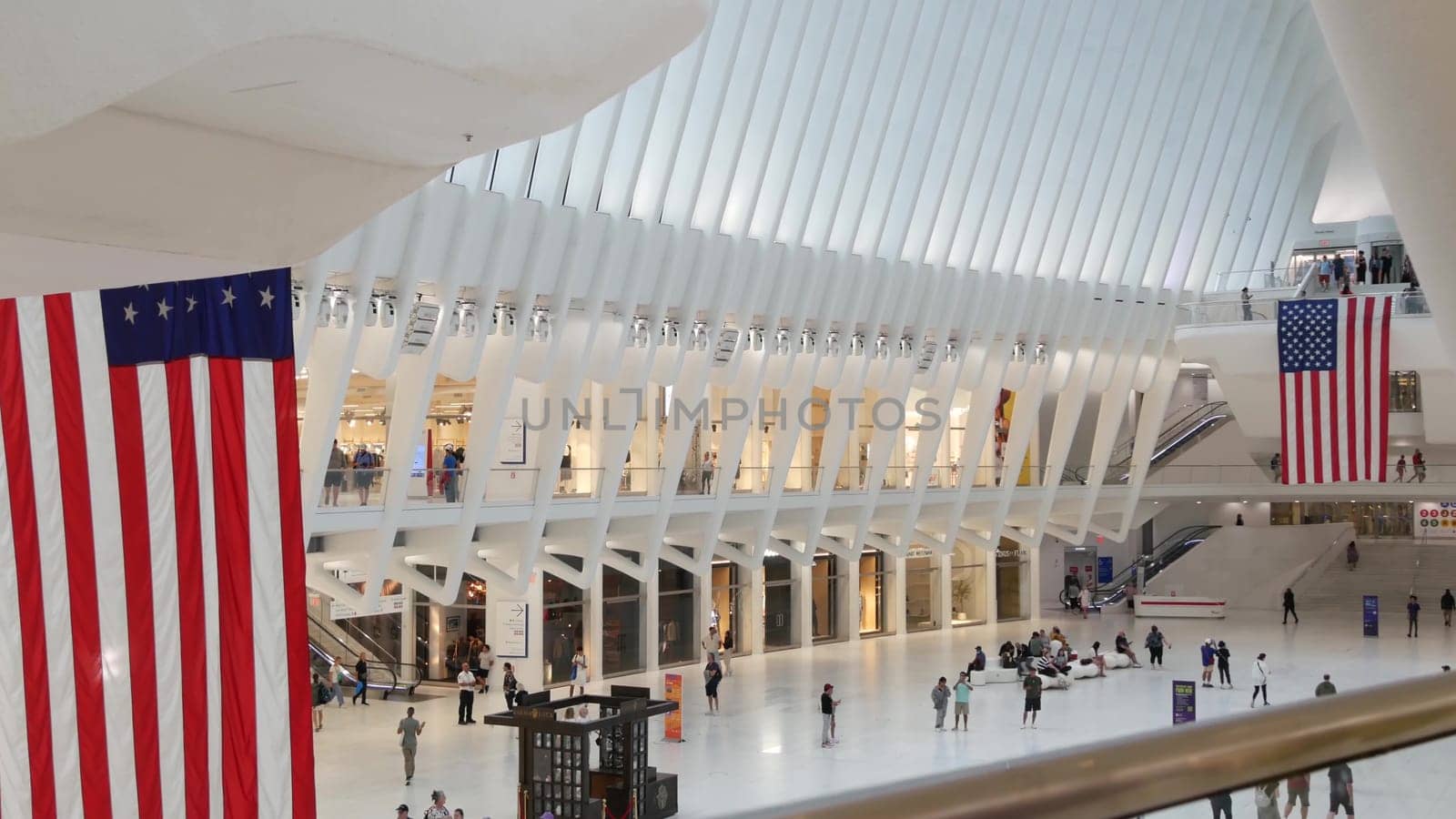 New York City, United States - 10 Sept 2023: World Trade Center Oculus transport hub architecture. Manhattan Downtown Financial District, USA urban life. People. September 11 remembrance american flag