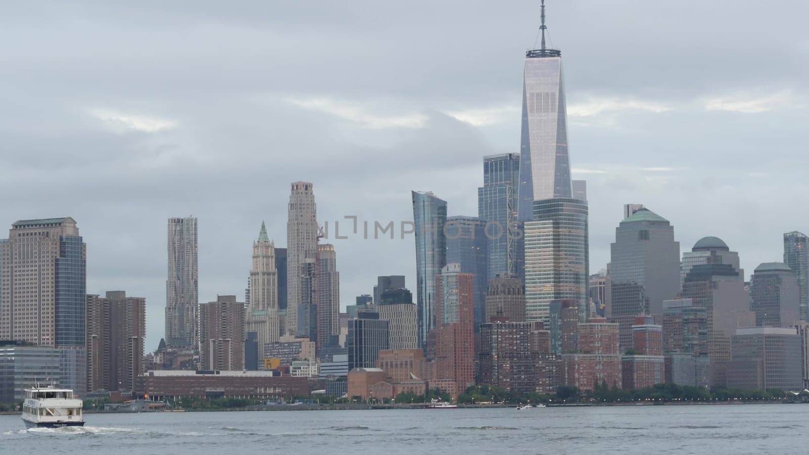 New York City, United States - 11 September 2023: Waterfront skyline, Manhattan Downtown, World Trade Center building. Riverfront skyscrapers from Pier A, Hoboken, New Jersey. Hudson river ferry boat.