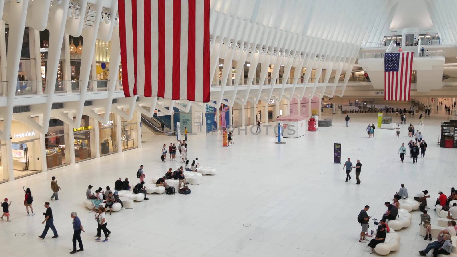 New York City, United States - 10 Sept 2023: World Trade Center Oculus transport hub architecture. Manhattan Downtown Financial District, USA urban life. People. September 11 remembrance american flag