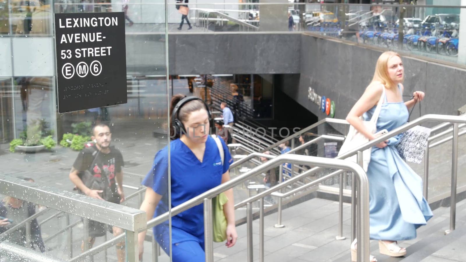 New York City, United States - 11 Sept 2023: Manhattan Midtown Lexington avenue, United States. People pedestrian exit underground subway station, stairs on 53 street, urban USA. Metro entrance sign.
