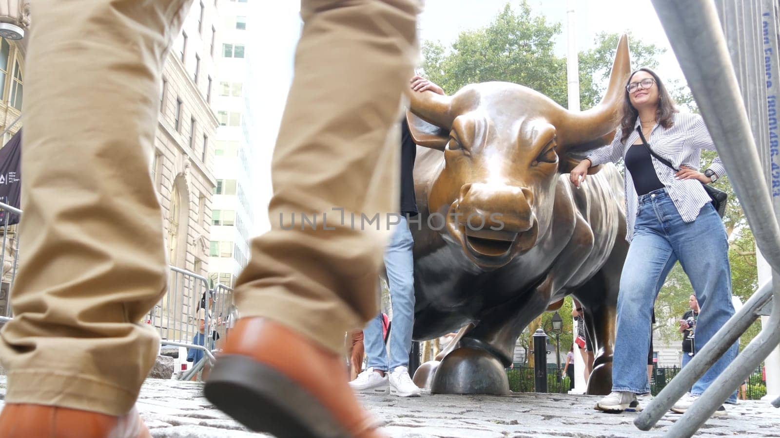 New York City, United States - 9 Sept 2023: Charging Bull, Wall street Stock Exchange symbol in USA. Lower Manhattan Downtown Financial District. American Broadway street. Tourist people photographing