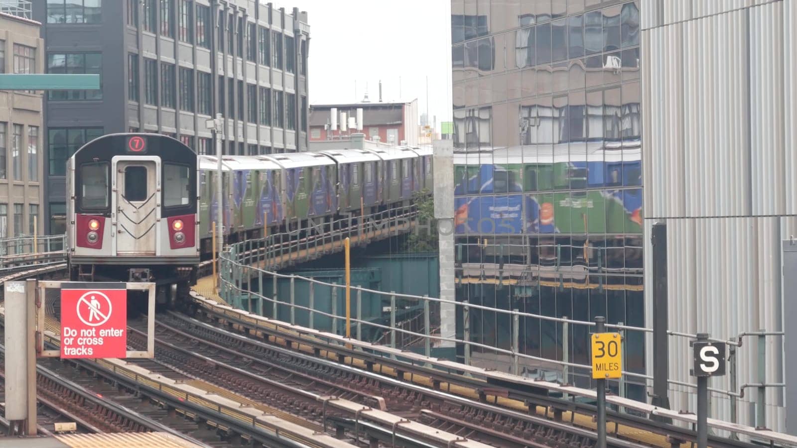 New York City, United States - 29 August 2023: Subway station. Metro train on public transportation platform. Elevated outdoor Court Square railway, Queens. NYC passenger railroad traffic, Long Island