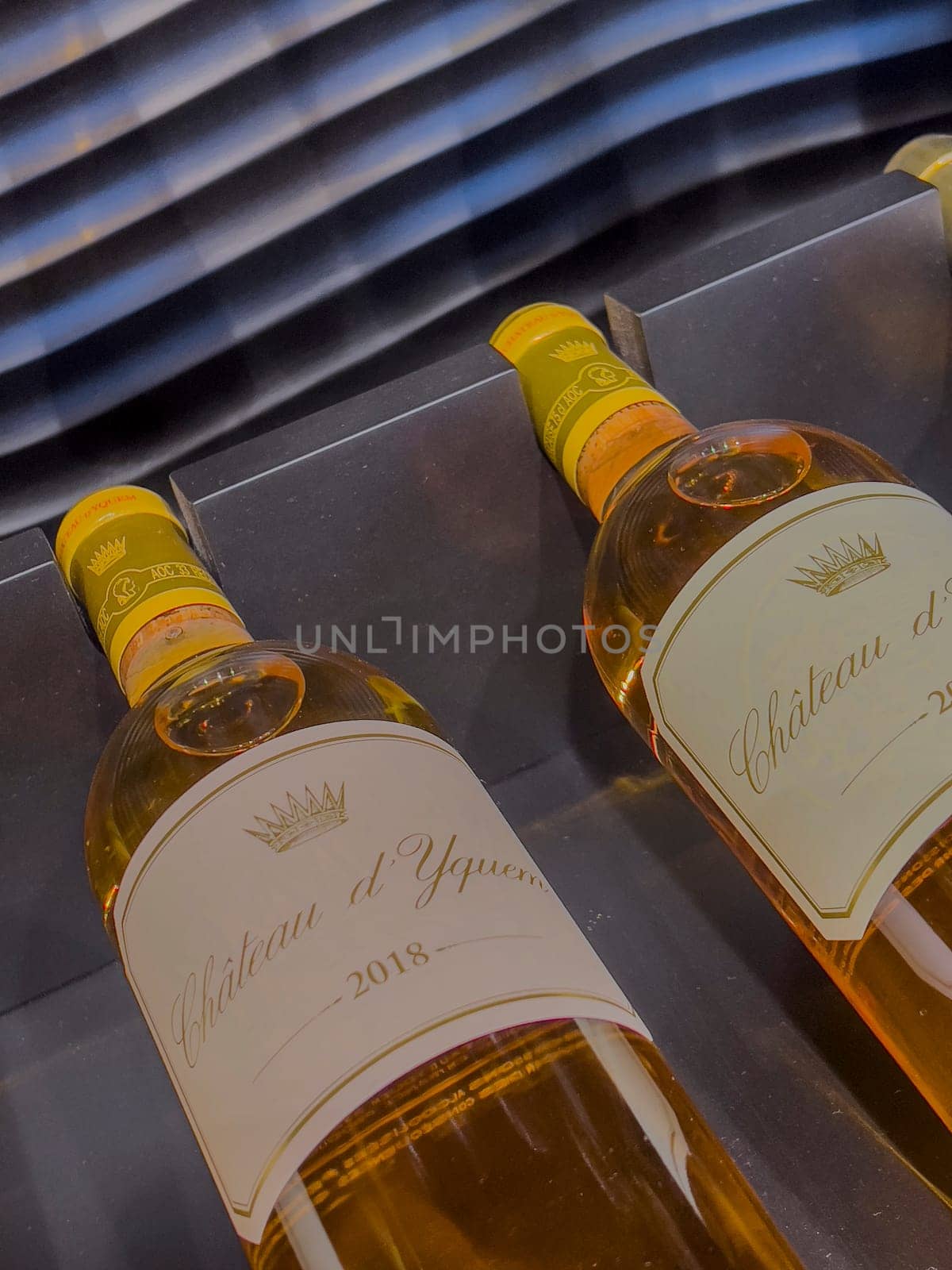 Two bottles of 2018 Sauternes wine are elegantly presented, highlighting the rich color and luxurious design that signifies a high-quality vintage selection.