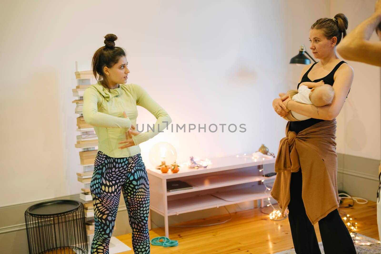 A yoga class showcasing women creatively engaging in movement while nurturing a deep connection with their baby