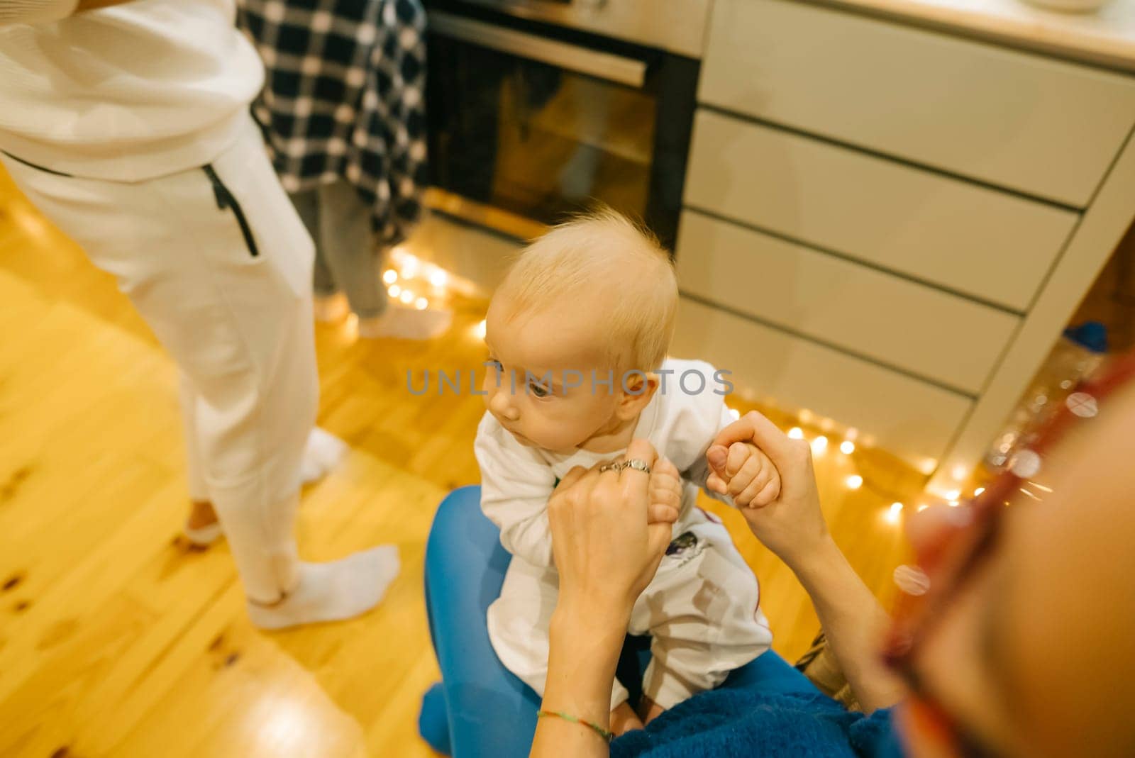 A heartwarming family moment unfolds as a baby joyfully interacts in a cozy and inviting kitchen environment